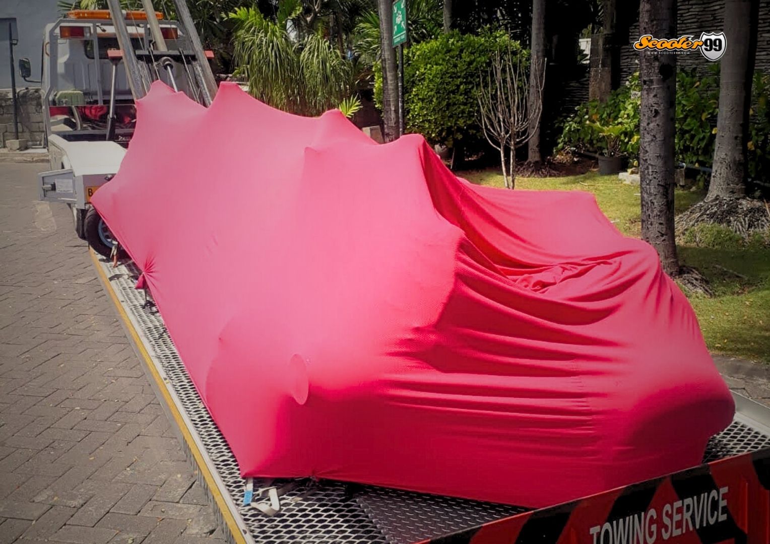 Towing truck in action, securing a vehicle on the roadside